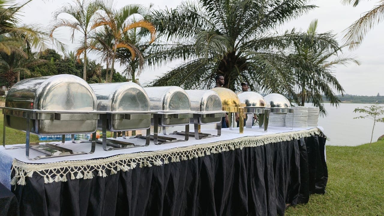 Silver chafing dishes at lakeside venue